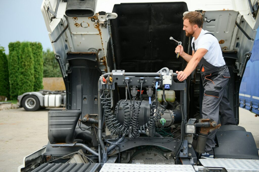 Professional truck mechanic working in vehicle repair service.